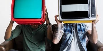 People holding retro television next to each other