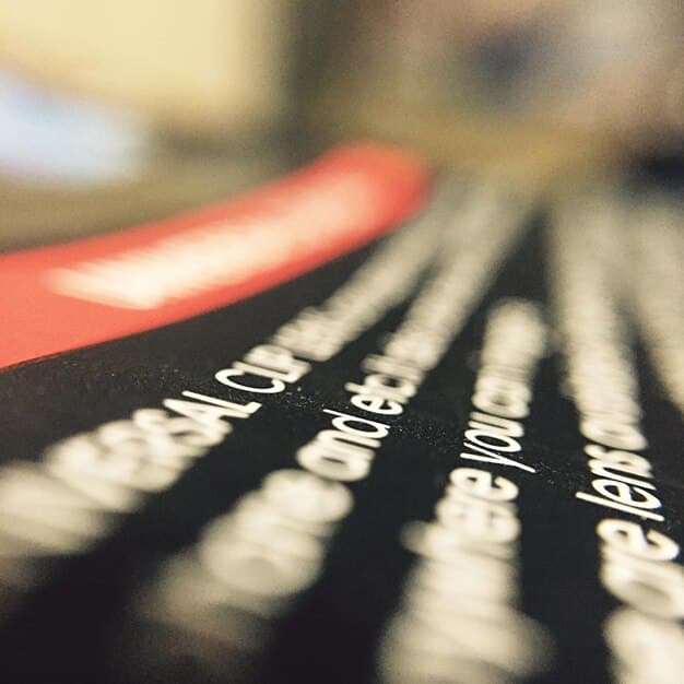 A close-up shot of a script for a cable TV original series, highlighting the meticulous detail and dedication to the writing process. The script is well-worn, suggesting numerous edits and revisions. On the side, there's a coffee cup and a pair of glasses, indicating long hours spent perfecting the story. The overall tone is professional and focused, emphasizing the effort behind creating high-quality content.