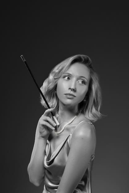 A black and white still from a limited series depicting an actress in a highly emotional scene, her face etched with grief and determination. The lighting is dramatic, casting deep shadows that enhance the mood.